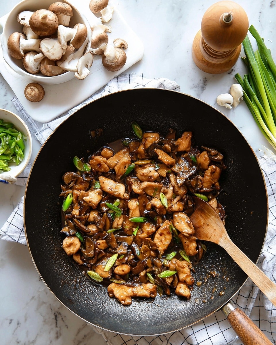 The image shows a black wok filled with a stir-fry dish made of golden-brown chicken pieces mixed with sliced brown mushrooms and bright green onion pieces. The chicken is cooked in a glossy dark brown sauce that coats each piece, giving a shiny texture. A wooden spoon is partially buried in the stir-fry, with its handle resting on the edge of the wok. Around the wok, there are fresh mushrooms in a white measuring cup, whole mushrooms, a wooden pepper grinder on a cutting board with green spring onions, and a white bowl with chopped green onions. The whole scene is set on a white marbled surface, with a white and blue checkered cloth under one edge of the wok. Photo taken with an iphone --ar 4:5 --v 7