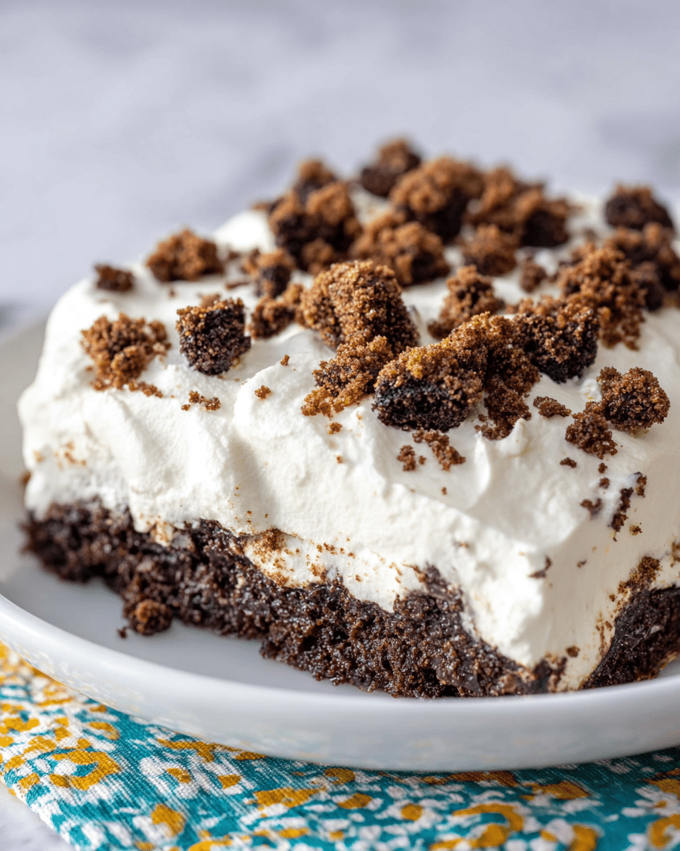 A slice of two-layer chocolate cake sits on a white plate with a white marbled texture underneath. The bottom and top layers are dark brown, moist chocolate cake with a slightly crumbly texture. Between these layers is a thick, smooth white cream layer, and the top of the cake is covered with another thick layer of the same white cream. Small chocolate cake crumbs are scattered on top of the cream. In the blurred background, there is the rest of the cake with the same two thick layers of dark brown chocolate and white cream. Photo taken with an iphone --ar 4:5 --v 7