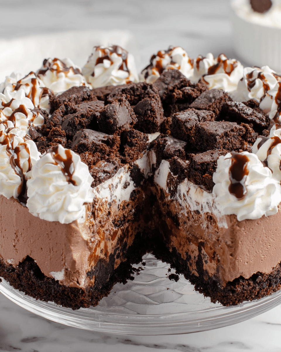This chocolate ice cream cake has three main layers: the bottom and top layers are smooth, dark chocolate ice cream, while the middle layer is a mix of crushed dark chocolate cookie pieces and chocolate ice cream. On top, there are many dark brown brownie chunks spread evenly across the surface, drizzled with dark chocolate syrup. Around the edge, there are piped swirls of white whipped cream with extra chocolate syrup on top. The cake is presented on a clear glass plate, set on a white marbled textured surface. Photo taken with an iphone --ar 4:5 --v 7