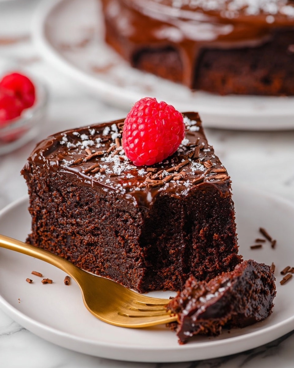 A round chocolate cake is cut into eight slices and placed on a white plate with a brown rim on a white marbled surface. The cake has a glossy dark chocolate top layer with small chocolate shavings scattered around. On top of the cake, there is a pile of bright red fresh raspberries and a few green leaves for decoration. The cake is lightly dusted with powdered sugar, with some sugar and raspberries scattered around the plate and surface. To the right side of the plate, there is a knife with a wooden handle resting on the surface. Photo taken with an iphone --ar 4:5 --v 7