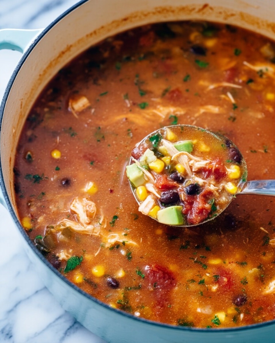 The image shows two bowls of colorful soup on a white marbled surface, topped with pieces of yellow corn, black olives, small cubes of green avocado, diced red tomatoes, shredded white and orange cheese, and fresh green cilantro. One bowl is fully visible and filled with a creamy, reddish-brown soup base with visible chunks of vegetables; it has a wedge of lime and a dollop of white sour cream on top, sprinkled with black pepper, and some thin, crispy tortilla strips. The other bowl is partially shown in the top right corner, similarly garnished. Next to the bowls is a slice of lime and some cilantro leaves, with a blue and white striped cloth nearby. The photo taken with an iphone --ar 4:5 --v 7
