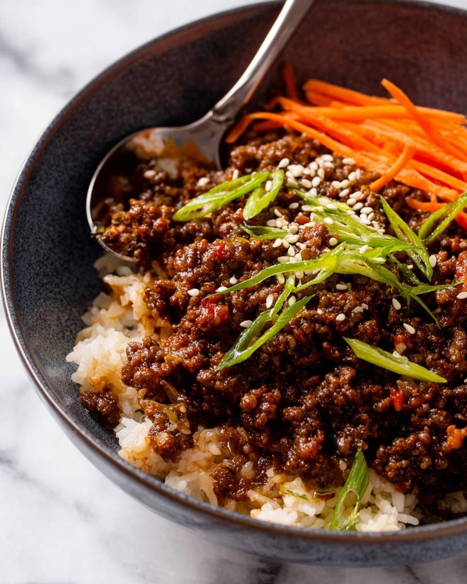 A white bowl filled with a layer of white rice at the bottom is topped with a thick layer of brown cooked ground meat mixed with a dark sauce and garnished with sesame seeds and a drizzle of red sauce. On one side, there are small green cucumber cubes, sliced round thin radishes, and a neat pile of thin orange carrot strips, all adding fresh colors around the meat. Thinly sliced green onions are scattered on top for a bright touch. A silver spoon rests inside the bowl, and the bowl sits on a soft gray cloth over a white marbled surface. photo taken with an iphone --ar 4:5 --v 7
