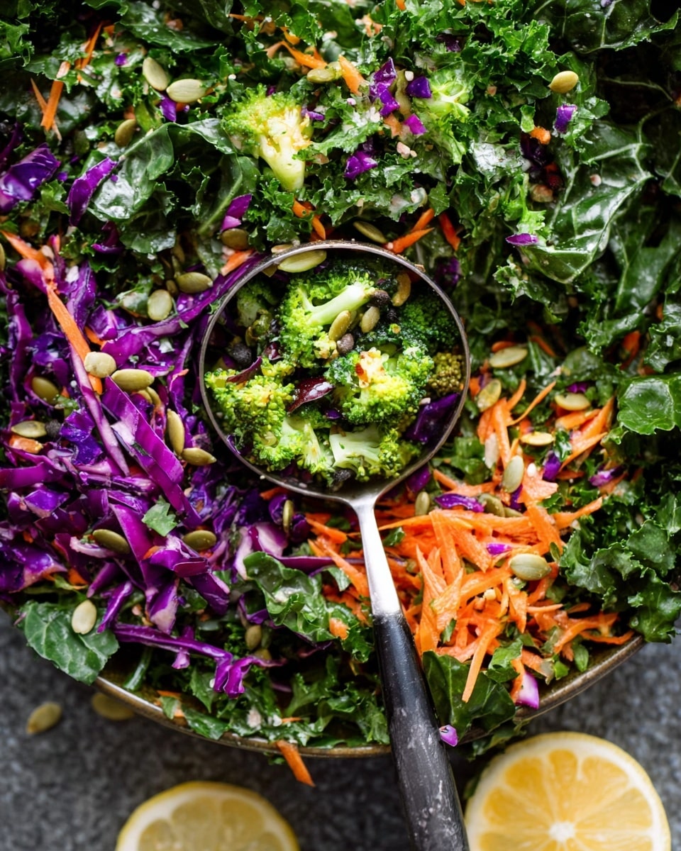 The image shows a colorful mixed vegetable salad with three main layers. The base layer is made of dark green leafy kale and spinach leaves, providing a leafy texture. The middle layer contains small bright green broccoli florets and thinly shredded orange carrots, adding crunch. The top layer is scattered with finely chopped purple cabbage, some light green parsley leaves, and sprinkled with small pumpkin seeds for extra texture. A silver and black utensil holds a scoop of the salad at the center, and a slice of lemon with a white marbled textured surface is visible on the side. photo taken with an iphone --ar 4:5 --v 7