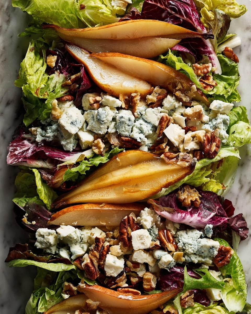 A close-up view of a salad showing three main layers: the first layer is a mix of green and purple leafy lettuce with different shapes; the second layer has golden-brown roasted pear slices with a slightly glossy surface; the third layer consists of creamy white cheese cubes with blue veins and small clusters of toasted brown nuts scattered evenly over the salad. The whole dish is placed on a white marbled texture background. photo taken with an iphone --ar 4:5 --v 7